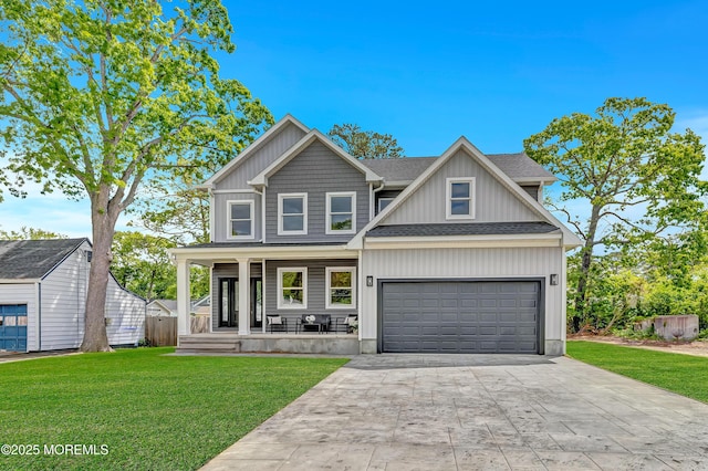 7 Cardinal Ave, Brick, NJ 08724 - view of front of property with a porch, roof with shingles, a front lawn, concrete driveway, and a garage