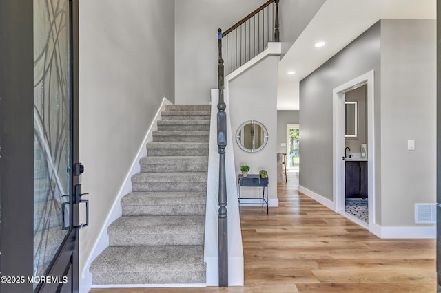 7 Cardinal Ave, Brick, NJ 08724 - staircase featuring wood finished floors, baseboards, recessed lighting, and a towering ceiling