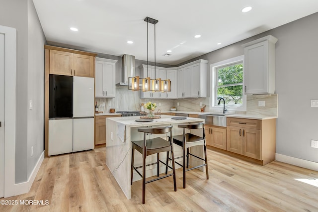 7 Cardinal Ave, Brick, NJ 08724 - kitchen featuring freestanding refrigerator, backsplash, light wood-style flooring, a breakfast bar, and recessed lighting