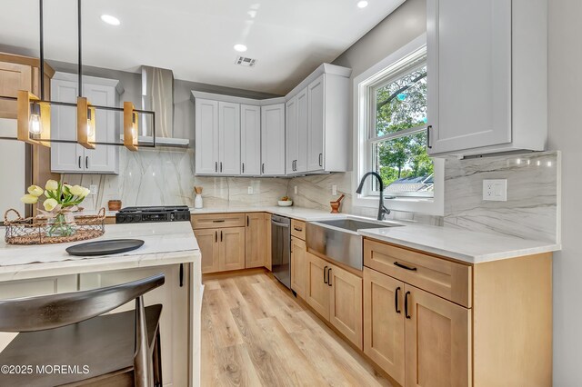 7 Cardinal Ave, Brick, NJ 08724 - kitchen with a sink, wall chimney range hood, stainless steel dishwasher, light countertops, and light wood finished floors