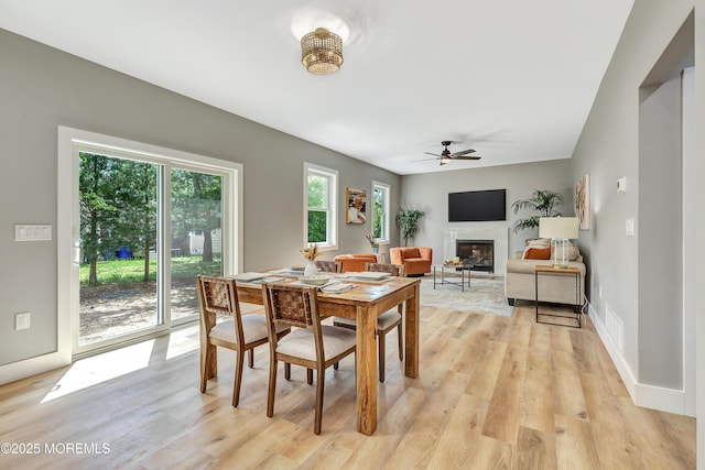 7 Cardinal Ave, Brick, NJ 08724 - dining area featuring light wood-type flooring, a fireplace, a ceiling fan, and baseboards