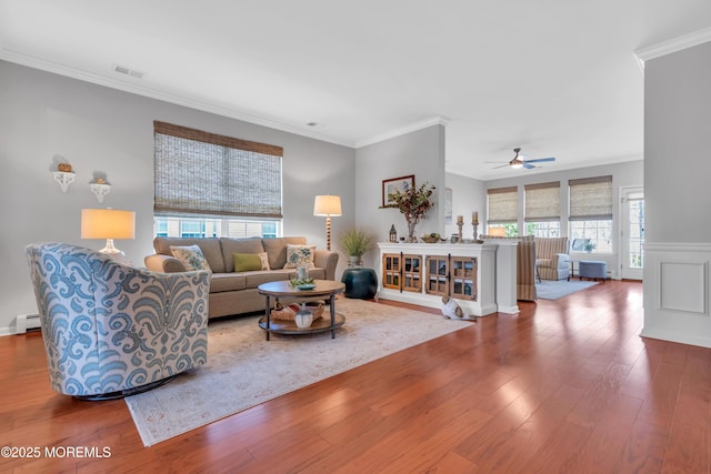 28 Pierhead Dr, Barnegat, NJ 08005 - living room with wood-type flooring, ornamental molding, ceiling fan, a baseboard heating unit, and wainscoting