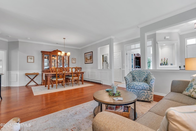 28 Pierhead Dr, Barnegat, NJ 08005 - living area with wood finished floors, crown molding, a chandelier, baseboard heating, and a decorative wall
