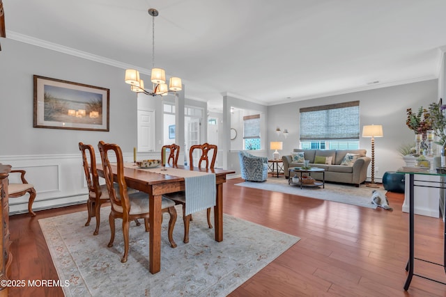 28 Pierhead Dr, Barnegat, NJ 08005 - dining area with crown molding, a chandelier, wood finished floors, a baseboard radiator, and a wainscoted wall