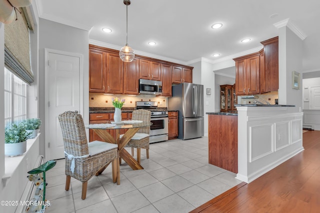 28 Pierhead Dr, Barnegat, NJ 08005 - kitchen with appliances with stainless steel finishes, dark countertops, crown molding, decorative backsplash, and pendant lighting