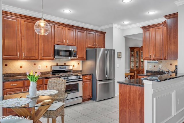 28 Pierhead Dr, Barnegat, NJ 08005 - kitchen with appliances with stainless steel finishes, decorative light fixtures, a peninsula, dark stone countertops, and ornamental molding