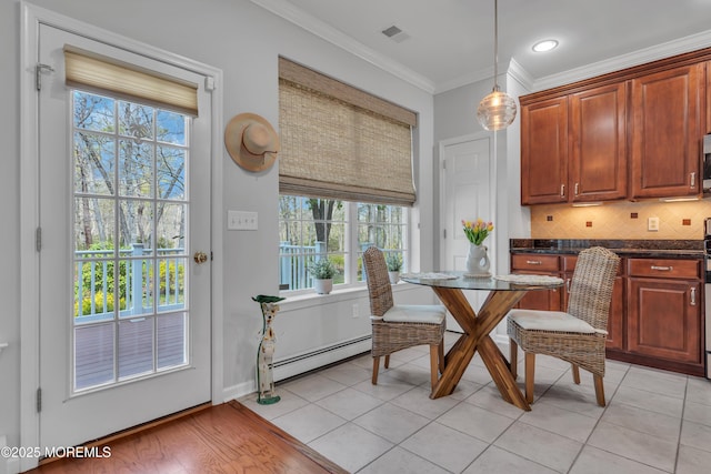 28 Pierhead Dr, Barnegat, NJ 08005 - dining space with a baseboard radiator, plenty of natural light, ornamental molding, and light tile patterned floors