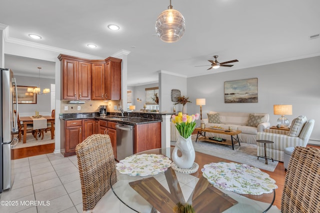 28 Pierhead Dr, Barnegat, NJ 08005 - kitchen with stainless steel appliances, open floor plan, a peninsula, ceiling fan, and ornamental molding