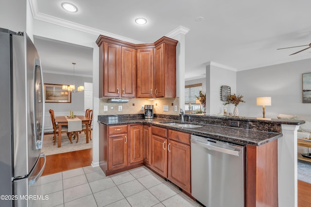 28 Pierhead Dr, Barnegat, NJ 08005 - kitchen with stainless steel appliances, a sink, ornamental molding, a peninsula, and dark stone countertops