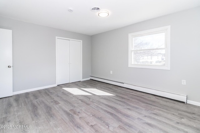 3 Fontana St, Toms River, NJ 08757 - unfurnished bedroom with baseboard heating, wood finished floors, a closet, and baseboards