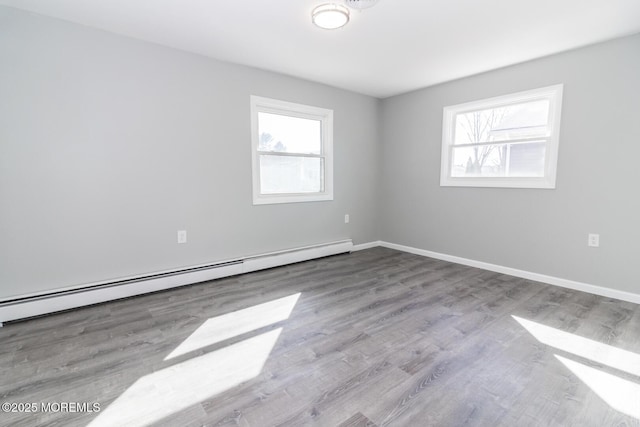 3 Fontana St, Toms River, NJ 08757 - empty room featuring baseboard heating, wood finished floors, and baseboards