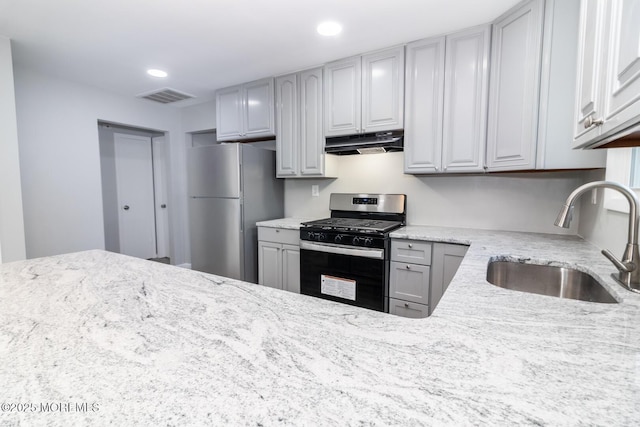3 Fontana St, Toms River, NJ 08757 - kitchen with appliances with stainless steel finishes, under cabinet range hood, a sink, gray cabinetry, and light stone counters