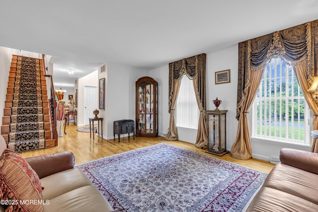 16 W Ave, Gladstone, NJ 07934 - living room featuring wood finished floors, stairway, and a chandelier