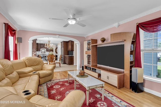 16 W Ave, Gladstone, NJ 07934 - living room featuring arched walkways, a chandelier, a ceiling fan, light wood finished floors, and crown molding