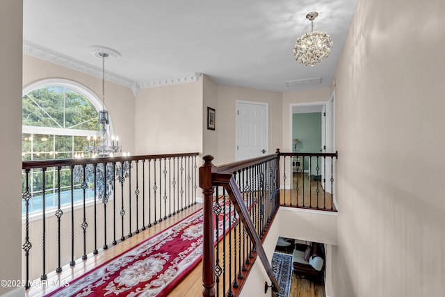 16 W Ave, Gladstone, NJ 07934 - hall featuring a chandelier, wood finished floors, an upstairs landing, and ornamental molding