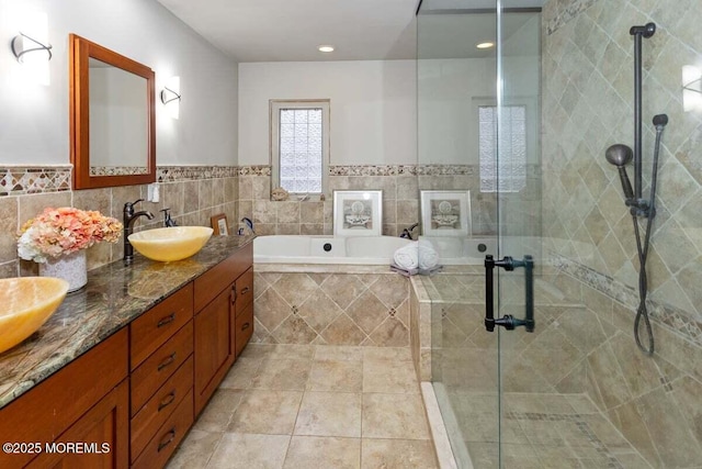 75 Brown Rd, Howell, NJ 07731 - full bathroom with a bath, double vanity, a shower stall, tile patterned floors, and tile walls