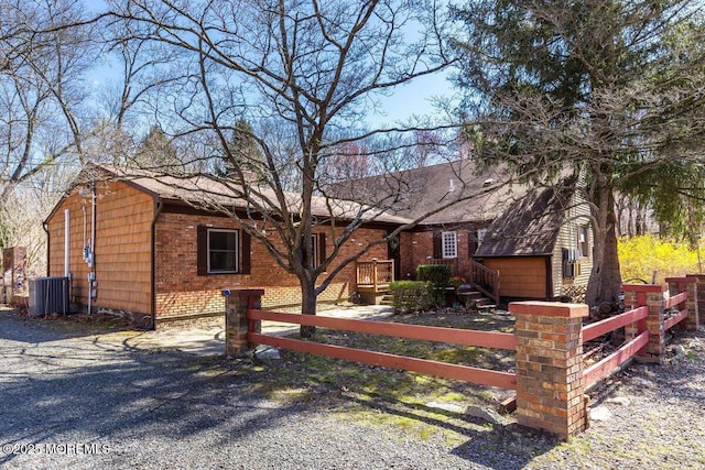 75 Brown Rd, Howell, NJ 07731 - ranch-style house with a fenced front yard, cooling unit, and brick siding