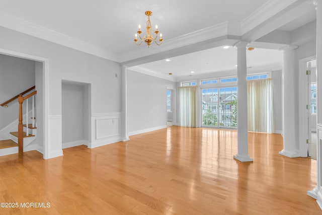 7 Centre St Unit 1303, Ocean Twp, NJ 07712 - unfurnished living room featuring decorative columns, stairs, light wood finished floors, crown molding, and a chandelier