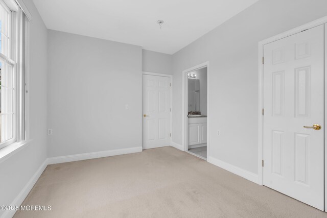 7 Centre St Unit 1303, Ocean Twp, NJ 07712 - unfurnished bedroom featuring light colored carpet, multiple windows, and baseboards