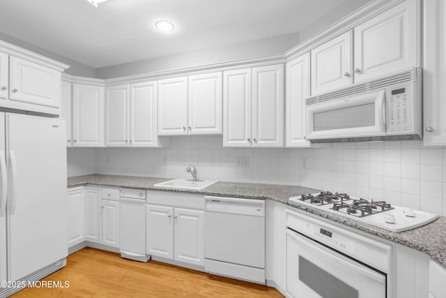 7 Centre St Unit 1303, Ocean Twp, NJ 07712 - kitchen with white appliances, a sink, white cabinetry, light wood finished floors, and decorative backsplash