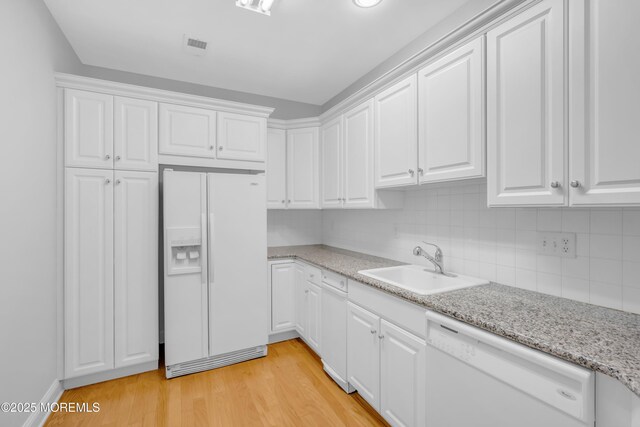 7 Centre St Unit 1303, Ocean Twp, NJ 07712 - kitchen featuring white appliances, a sink, light wood-type flooring, and white cabinets