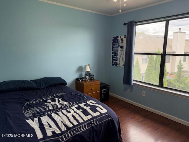 372 Oak Knoll Dr, Manalapan, NJ 07726 - bedroom featuring wood finished floors, crown molding, and baseboards