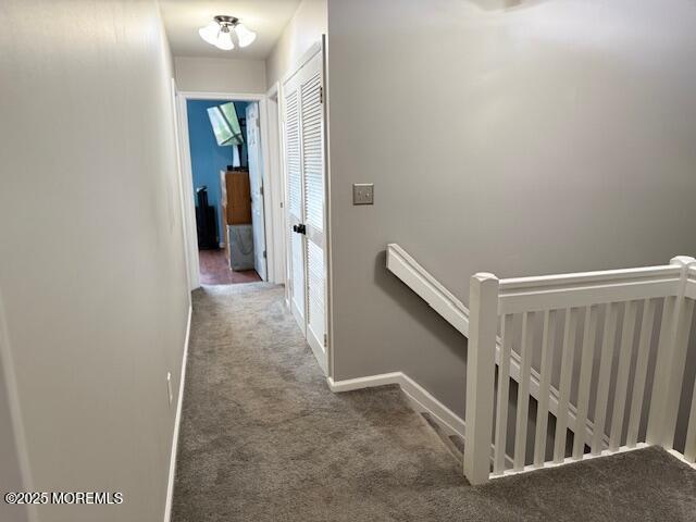372 Oak Knoll Dr, Manalapan, NJ 07726 - hallway with carpet, an upstairs landing, and baseboards