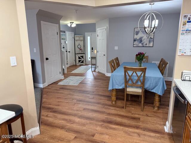 372 Oak Knoll Dr, Manalapan, NJ 07726 - dining area with a chandelier, light wood-type flooring, and baseboards