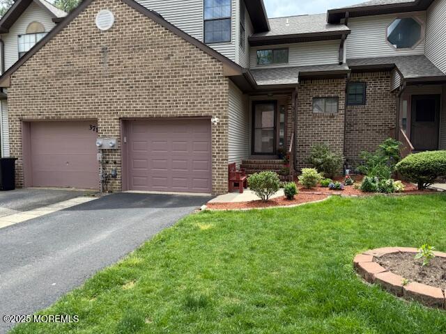 372 Oak Knoll Dr, Manalapan, NJ 07726 - view of front of house with brick siding, asphalt driveway, a garage, and a front lawn