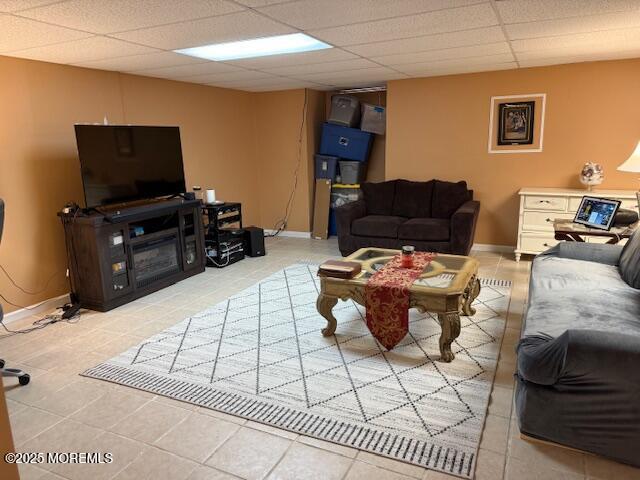372 Oak Knoll Dr, Manalapan, NJ 07726 - living area with light tile patterned floors, a paneled ceiling, and baseboards