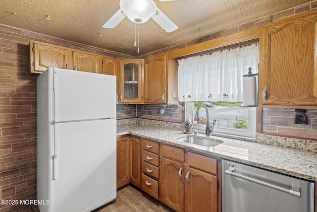 388 Atlantic Ave, Long Branch, NJ 07740 - kitchen featuring freestanding refrigerator, dishwasher, a sink, light stone counters, and ceiling fan