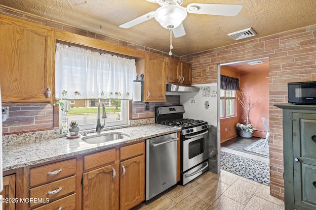 388 Atlantic Ave, Long Branch, NJ 07740 - kitchen featuring a sink, stainless steel appliances, ceiling fan, a textured ceiling, and brown cabinets