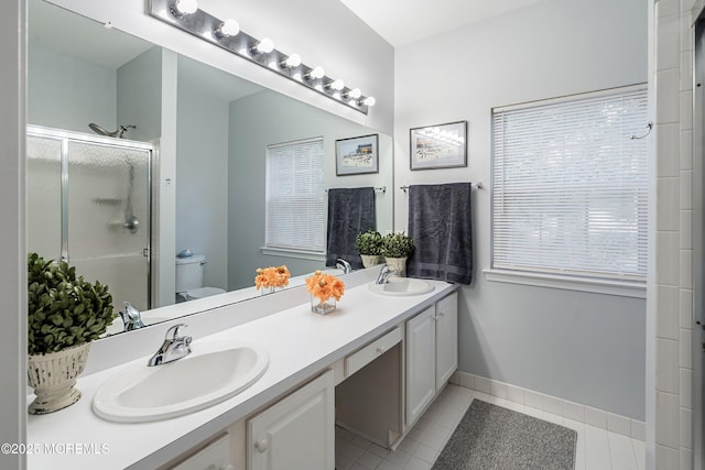 37 Violet Ct, Holmdel, NJ 07733 - full bath featuring toilet, double vanity, a shower stall, tile patterned floors, and baseboards