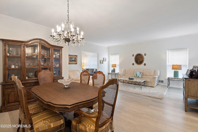 37 Violet Ct, Holmdel, NJ 07733 - dining room featuring a chandelier, crown molding, and light wood-type flooring