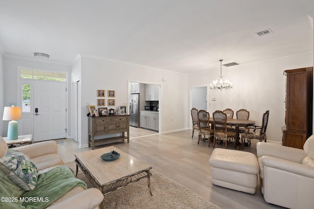 37 Violet Ct, Holmdel, NJ 07733 - living room featuring a chandelier, ornamental molding, light wood finished floors, and baseboards