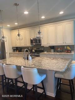 18 Lily Pond Ct, Howell, NJ 07731 - kitchen featuring stainless steel appliances, a breakfast bar area, recessed lighting, and a sink