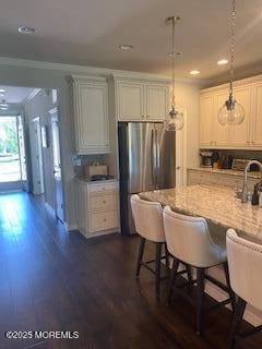 18 Lily Pond Ct, Howell, NJ 07731 - kitchen with freestanding refrigerator, dark wood-type flooring, light stone counters, recessed lighting, and decorative light fixtures