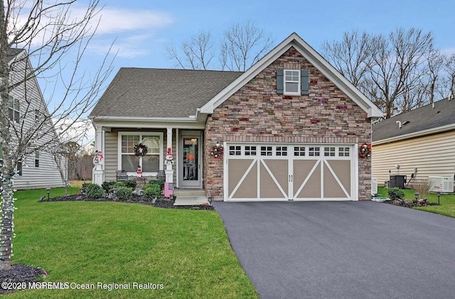 18 Lily Pond Ct, Howell, NJ 07731 - craftsman house with driveway, a front yard, stone siding, and roof with shingles