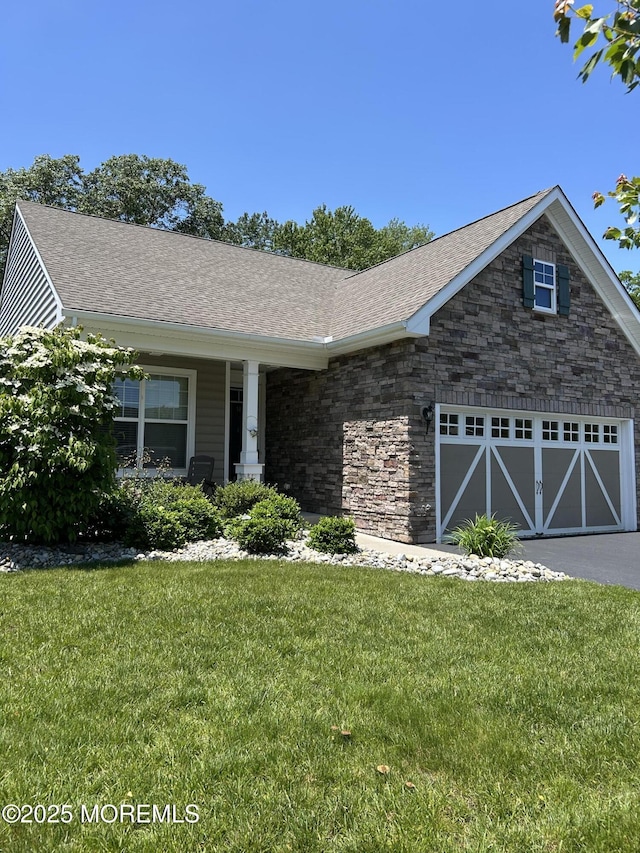 18 Lily Pond Ct, Howell, NJ 07731 - view of front of property featuring a front lawn, an attached garage, roof with shingles, and asphalt driveway