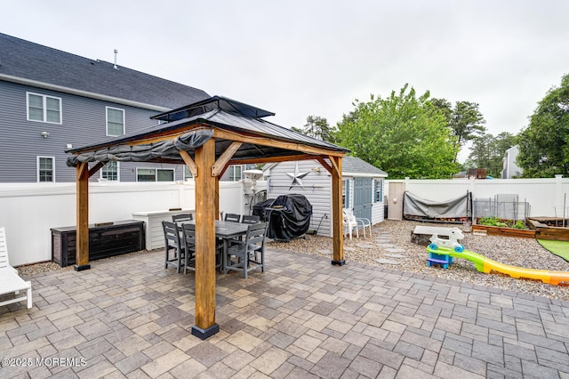 909 Amsterdam Ave, Toms River, NJ 08757 - fenced backyard with a gazebo, a patio area, outdoor dining area, and a grill
