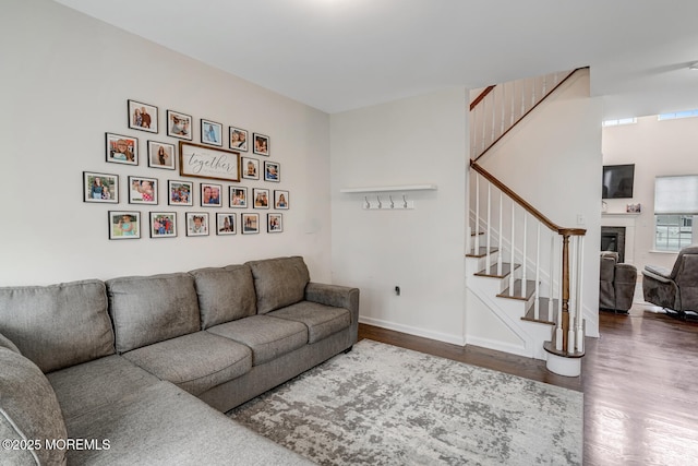 909 Amsterdam Ave, Toms River, NJ 08757 - living room with stairs, wood finished floors, a fireplace, and baseboards