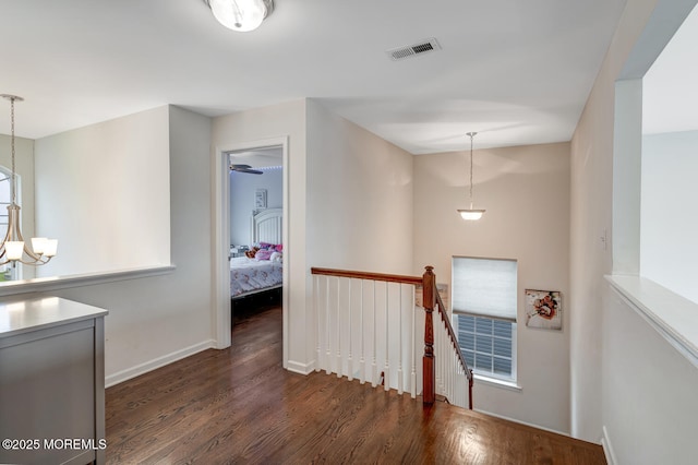 909 Amsterdam Ave, Toms River, NJ 08757 - corridor with an upstairs landing, wood finished floors, a chandelier, and baseboards