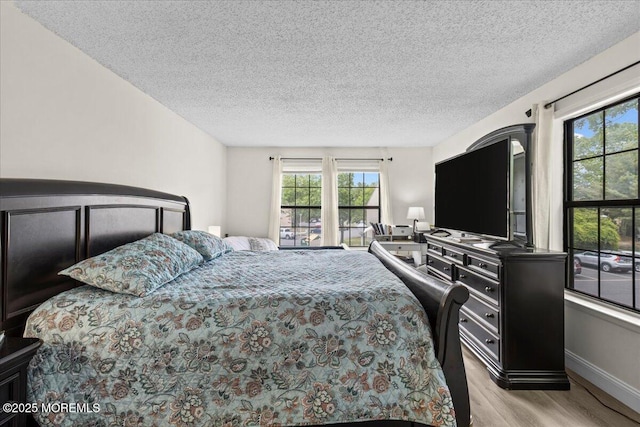 2001 Begonia Ct, Jackson, NJ 08527 - bedroom featuring multiple windows, wood finished floors, a textured ceiling, and baseboards