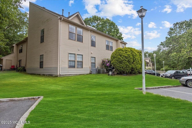 2001 Begonia Ct, Jackson, NJ 08527 - view of side of property with a lawn, uncovered parking, and central air condition unit