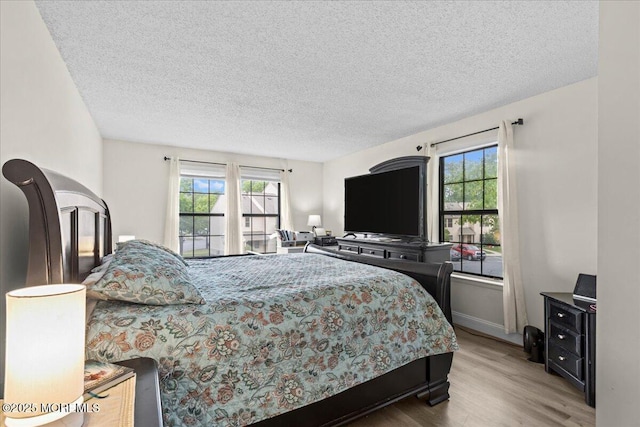 2001 Begonia Ct, Jackson, NJ 08527 - bedroom with multiple windows, wood finished floors, and a textured ceiling