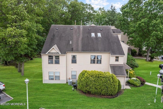 2001 Begonia Ct, Jackson, NJ 08527 - rear view of property featuring a lawn, a shingled roof, and view of wooded area