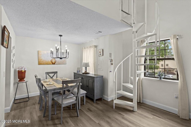 2001 Begonia Ct, Jackson, NJ 08527 - dining area featuring wood finished floors, a chandelier, baseboards, and a textured ceiling