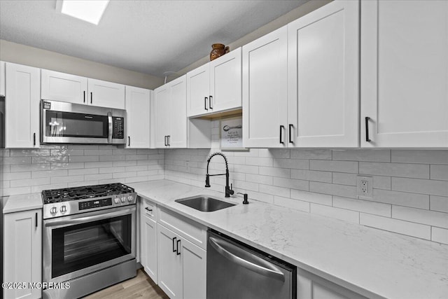 2001 Begonia Ct, Jackson, NJ 08527 - kitchen featuring appliances with stainless steel finishes, a sink, and white cabinetry