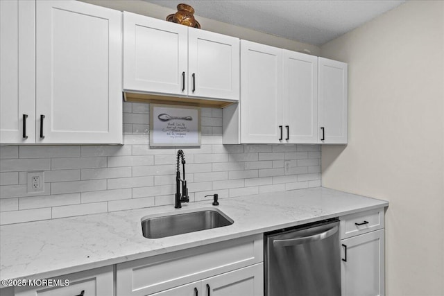 2001 Begonia Ct, Jackson, NJ 08527 - kitchen featuring stainless steel dishwasher, a sink, white cabinets, decorative backsplash, and light stone counters