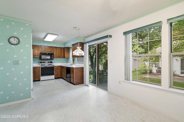 11 Sedgwick Sq, Jackson, NJ 08527 - kitchen with black appliances, light countertops, baseboards, a sink, and brown cabinetry